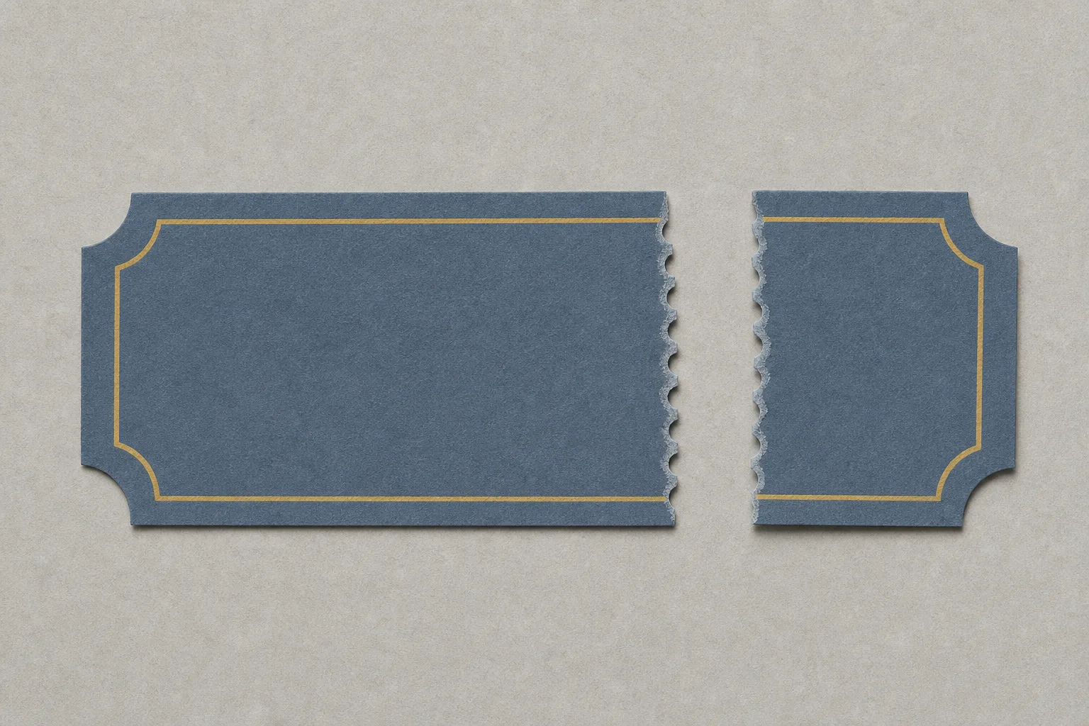 A blank slate-blue paper ticket torn in two along its perforations, the large portion lying on the left and the small stub set apart on the right with an empty gap between the ragged edges.